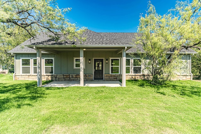 rear view of property featuring a yard