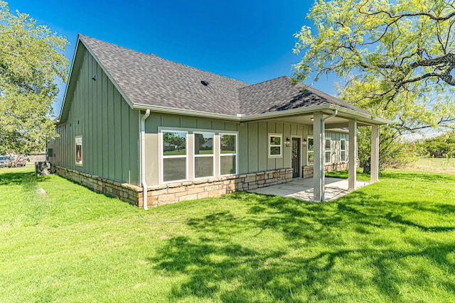 back of property with a patio and a lawn