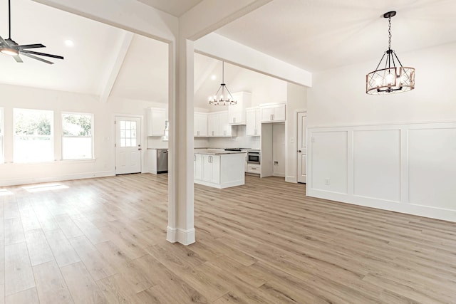 unfurnished living room featuring vaulted ceiling with beams, ceiling fan with notable chandelier, and light hardwood / wood-style floors