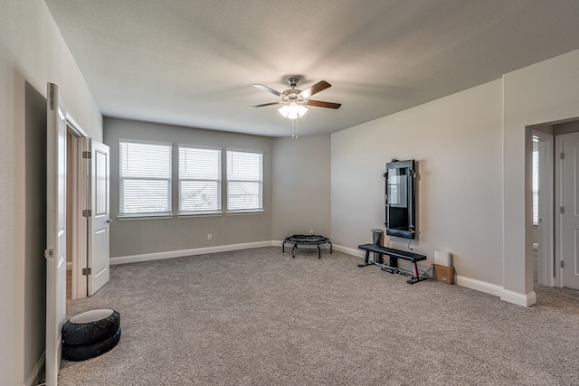 living area featuring carpet and ceiling fan