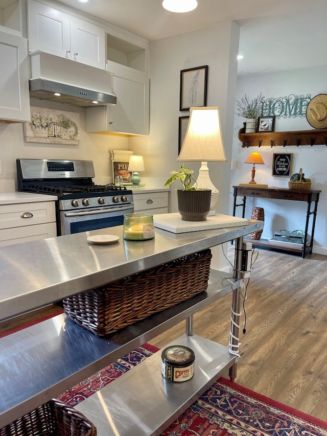 kitchen featuring white cabinets, stainless steel counters, and stainless steel range with gas stovetop