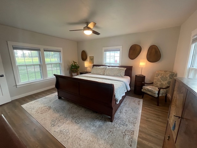 bedroom with ceiling fan and dark wood-type flooring