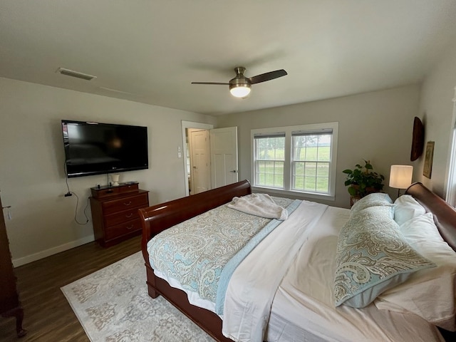 bedroom with ceiling fan and dark hardwood / wood-style floors