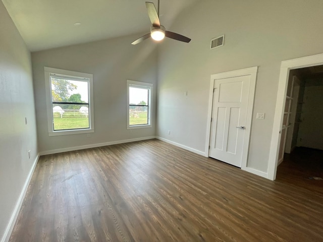 unfurnished room featuring high vaulted ceiling, ceiling fan, and dark hardwood / wood-style flooring