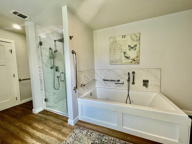 bathroom with shower with separate bathtub and hardwood / wood-style flooring