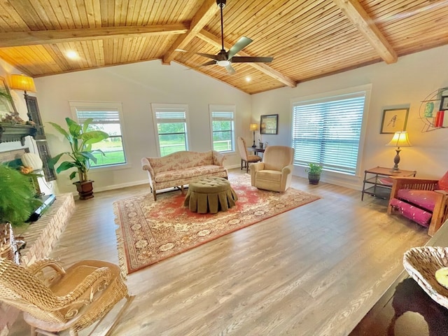 living room with vaulted ceiling with beams, wood ceiling, light hardwood / wood-style flooring, and ceiling fan