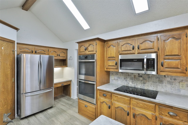 kitchen with light hardwood / wood-style floors, backsplash, appliances with stainless steel finishes, and vaulted ceiling with beams