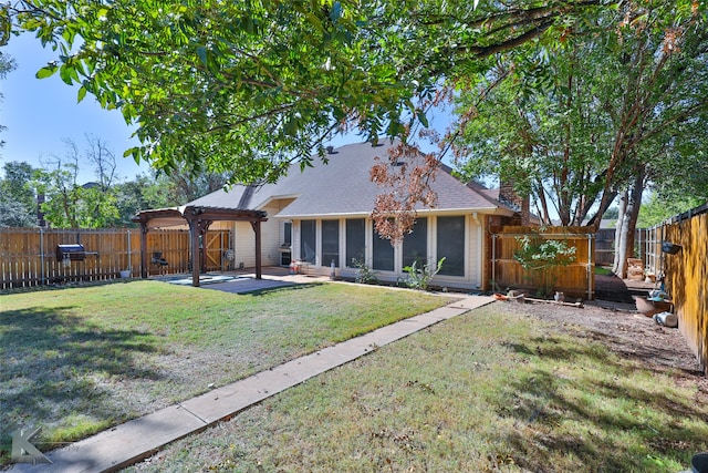 back of house featuring a patio area and a lawn