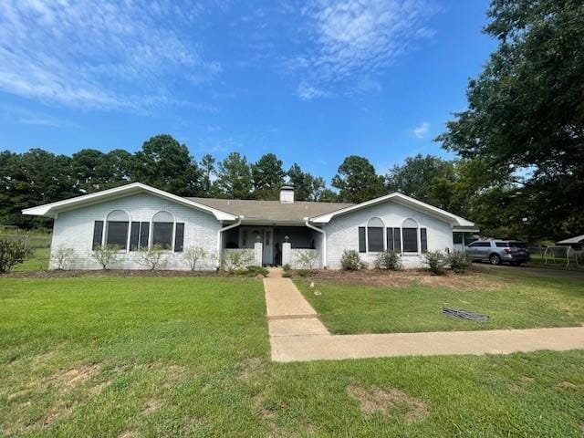 ranch-style home with a front lawn