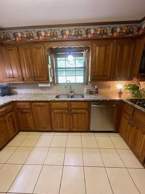 kitchen featuring backsplash, sink, light tile patterned floors, and stainless steel dishwasher