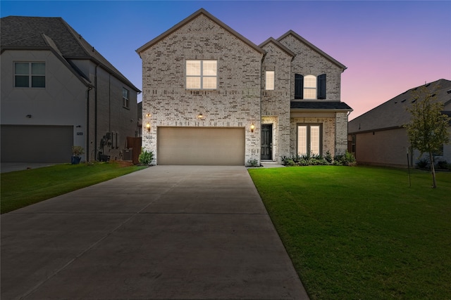 view of front facade featuring a yard and a garage