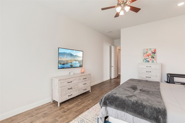 bedroom with ceiling fan and dark hardwood / wood-style floors