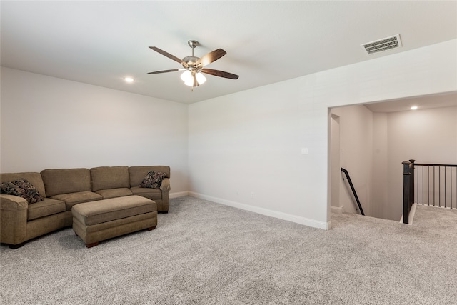 carpeted living room with ceiling fan