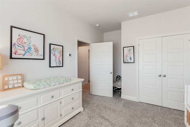 bedroom with a closet and light colored carpet