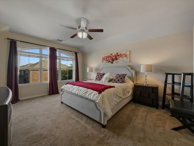 carpeted bedroom featuring vaulted ceiling and ceiling fan