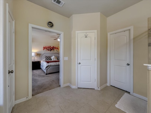 corridor featuring light colored carpet