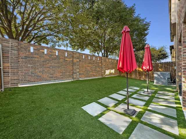 view of yard with a patio and central AC unit