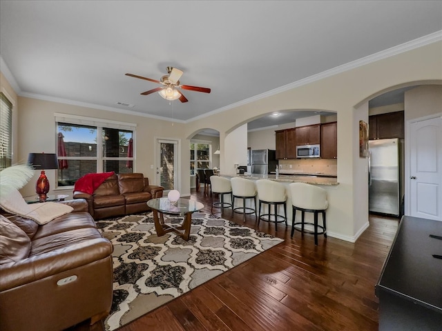 living room featuring crown molding, ceiling fan, and dark hardwood / wood-style floors