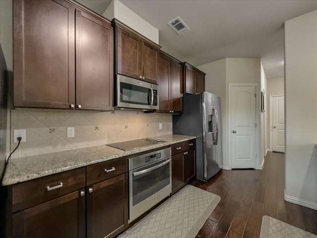 kitchen featuring dark brown cabinetry, appliances with stainless steel finishes, dark hardwood / wood-style flooring, and light stone counters