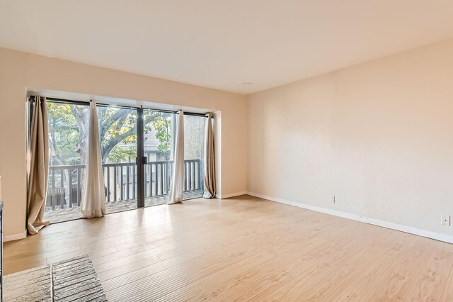 unfurnished living room with a fireplace and light hardwood / wood-style floors