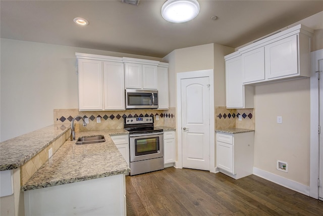 kitchen featuring stainless steel appliances, sink, dark hardwood / wood-style flooring, and white cabinetry