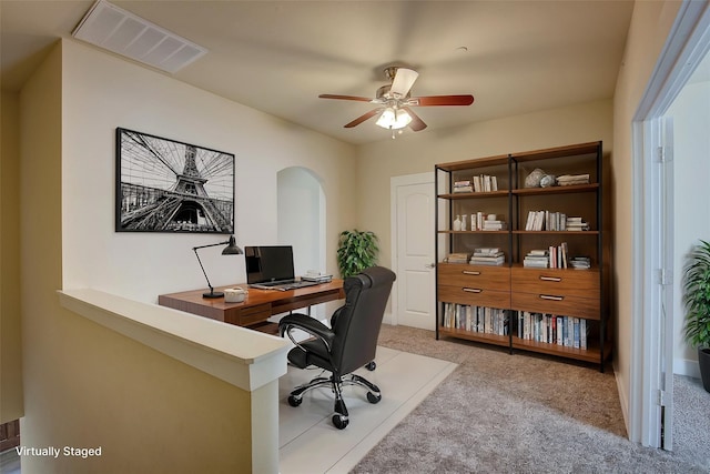 carpeted office with ceiling fan