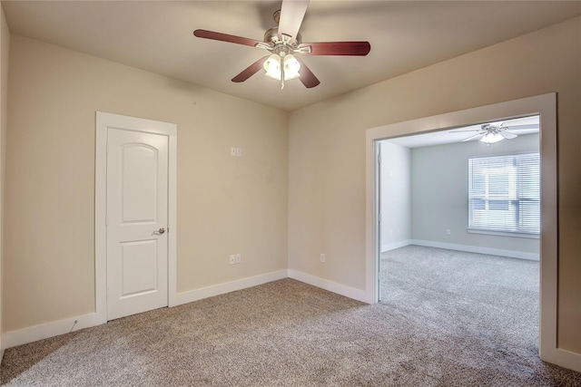 unfurnished room featuring light colored carpet and ceiling fan