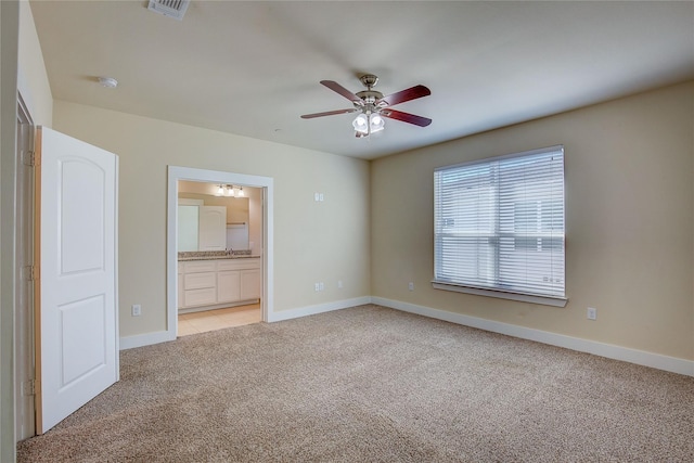 empty room with ceiling fan and light colored carpet