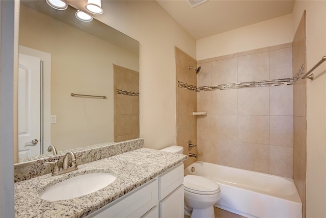 full bathroom with vanity, toilet, and tiled shower / bath