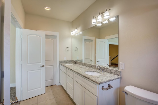 bathroom featuring tile patterned flooring, vanity, and toilet