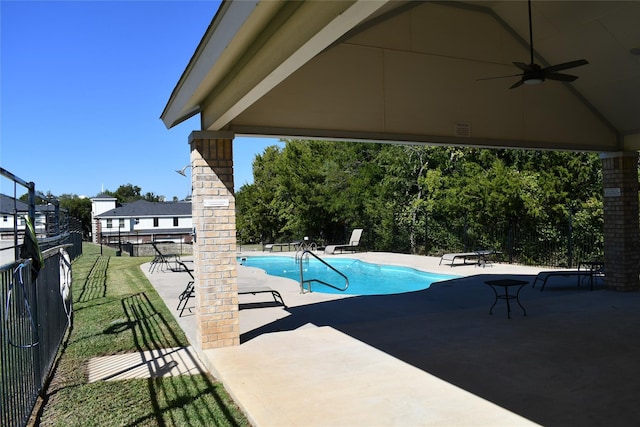 view of pool with a yard, ceiling fan, and a patio area