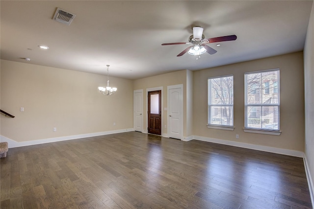 unfurnished living room featuring ceiling fan with notable chandelier and dark wood-type flooring