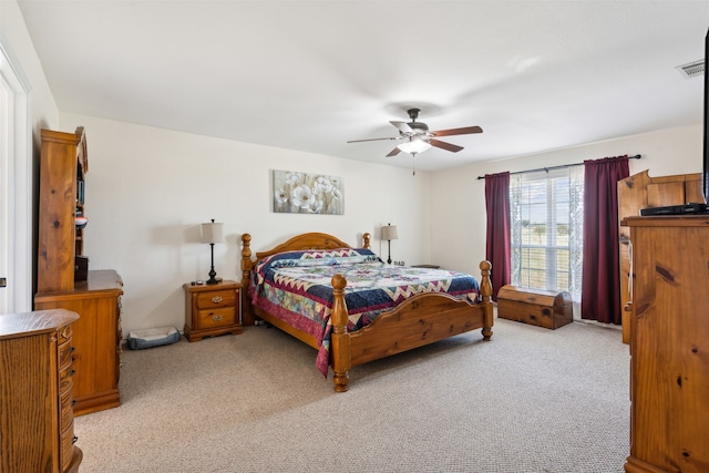 bedroom with light carpet and ceiling fan