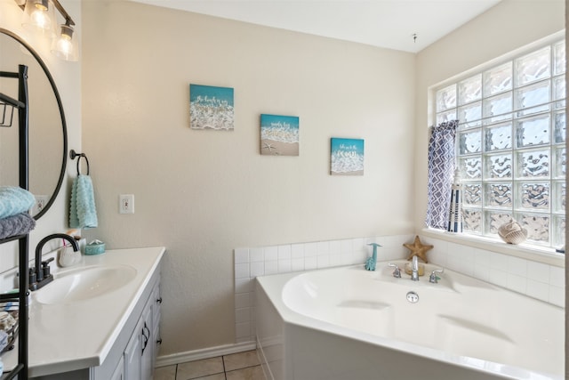 bathroom featuring tile patterned floors, a tub to relax in, and vanity