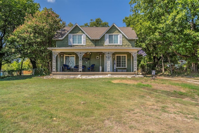 view of front of property featuring covered porch and a front yard