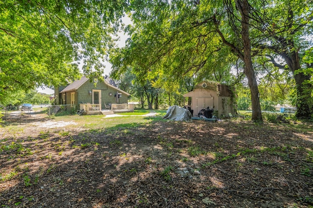 view of yard featuring a shed and a wooden deck