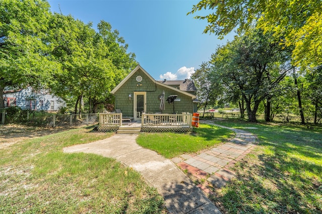 view of front facade with a front lawn and a wooden deck