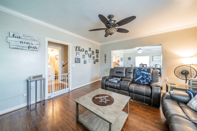 living room with ornamental molding, ceiling fan, and dark wood-type flooring