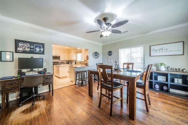 dining room featuring ornamental molding, hardwood / wood-style flooring, and ceiling fan