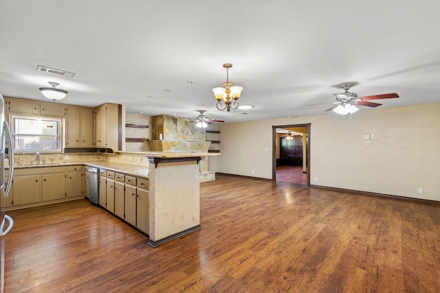 kitchen with pendant lighting, sink, kitchen peninsula, dark wood-type flooring, and a chandelier