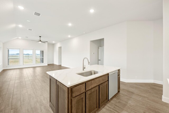 dining space featuring light hardwood / wood-style floors, vaulted ceiling, and sink