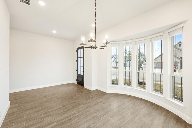 kitchen with stainless steel appliances, light wood-type flooring, a wealth of natural light, and white cabinetry