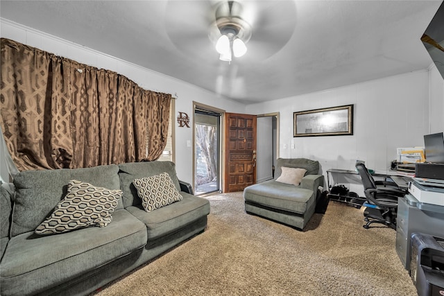 living room with ornamental molding, carpet floors, and ceiling fan