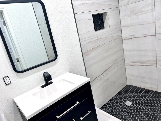 bathroom featuring vanity and tiled shower