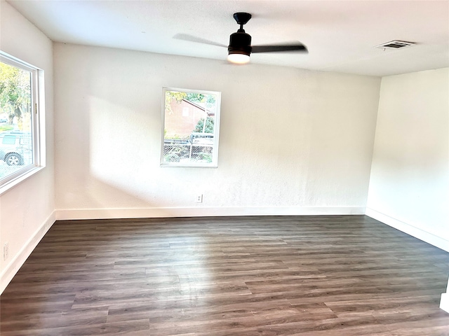 unfurnished room featuring dark wood-type flooring and ceiling fan