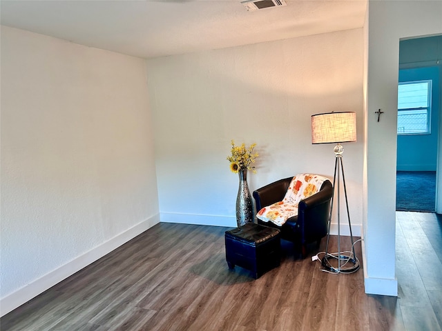 sitting room with dark hardwood / wood-style flooring