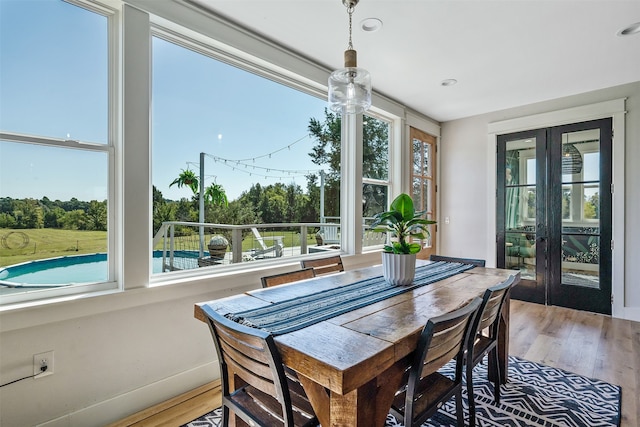 dining area with plenty of natural light, baseboards, and light wood-style floors