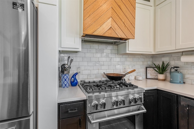 kitchen featuring light countertops, custom range hood, white cabinets, and stainless steel appliances