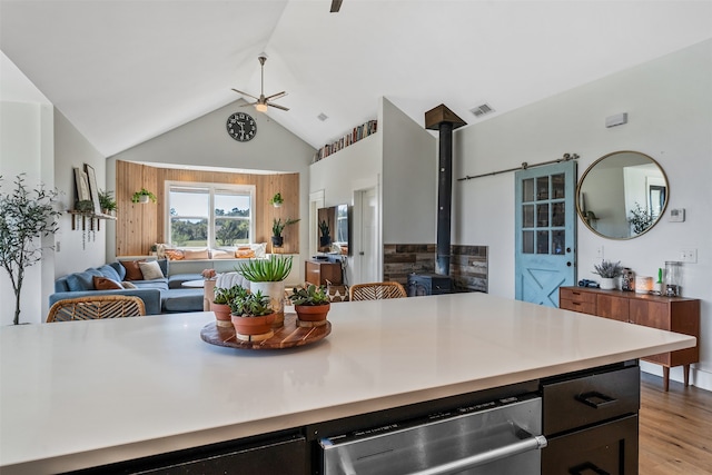 kitchen with visible vents, ceiling fan, open floor plan, dishwasher, and light wood-type flooring