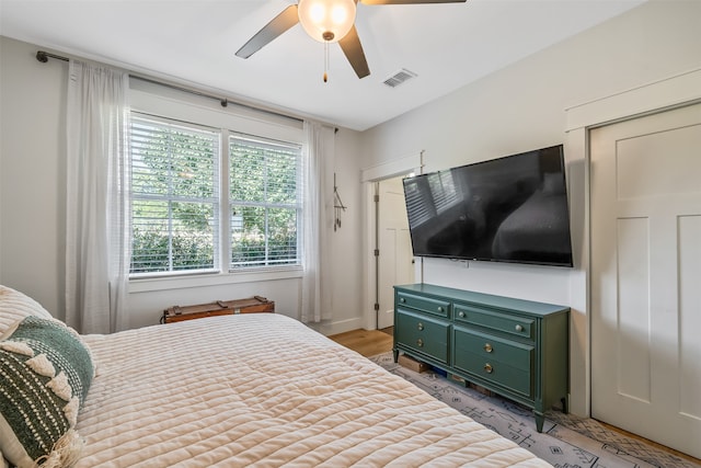 bedroom with ceiling fan and light hardwood / wood-style floors